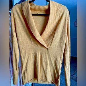 Small light weight sweater. Can be dressy or casual. Very flattering.